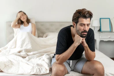 selective-husband-sitting-bed-with-feel-bored-about-her-wife (1)